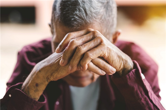 photo senior man covering his face with his hands