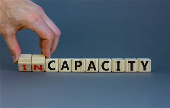 capacity or incapacity man turns wooden cubes and changes the word