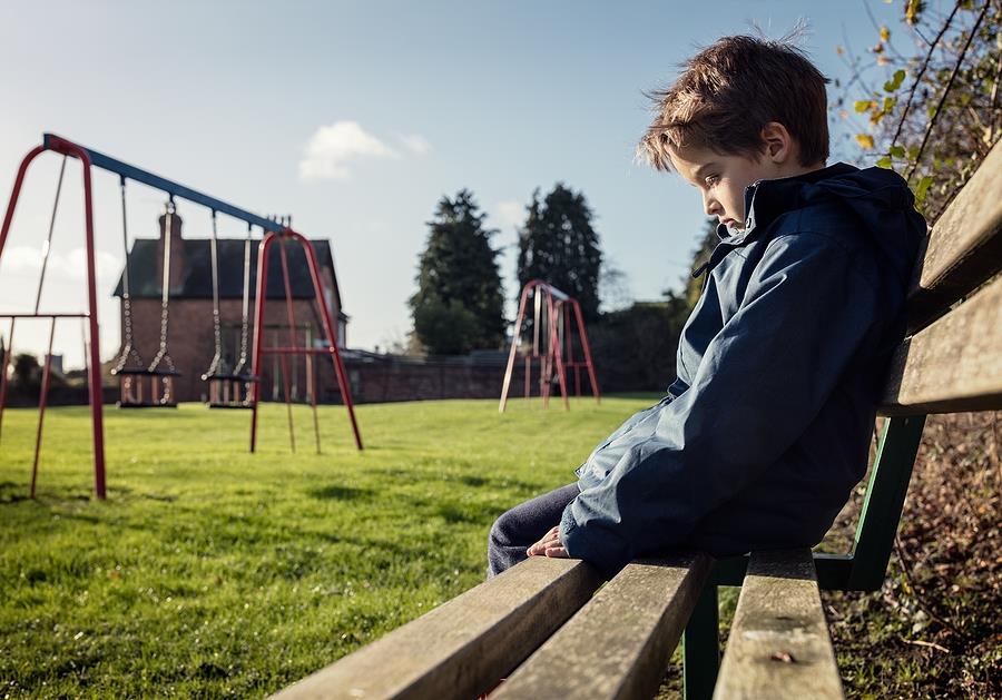 Upset problem child sitting on bench